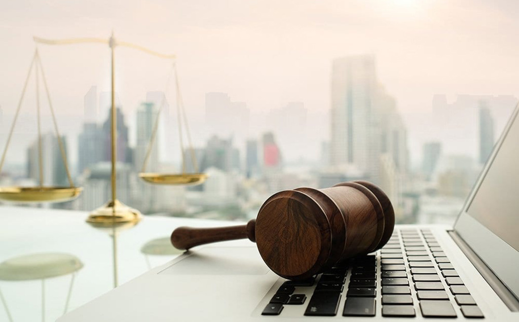 Gavel on laptop with city in background