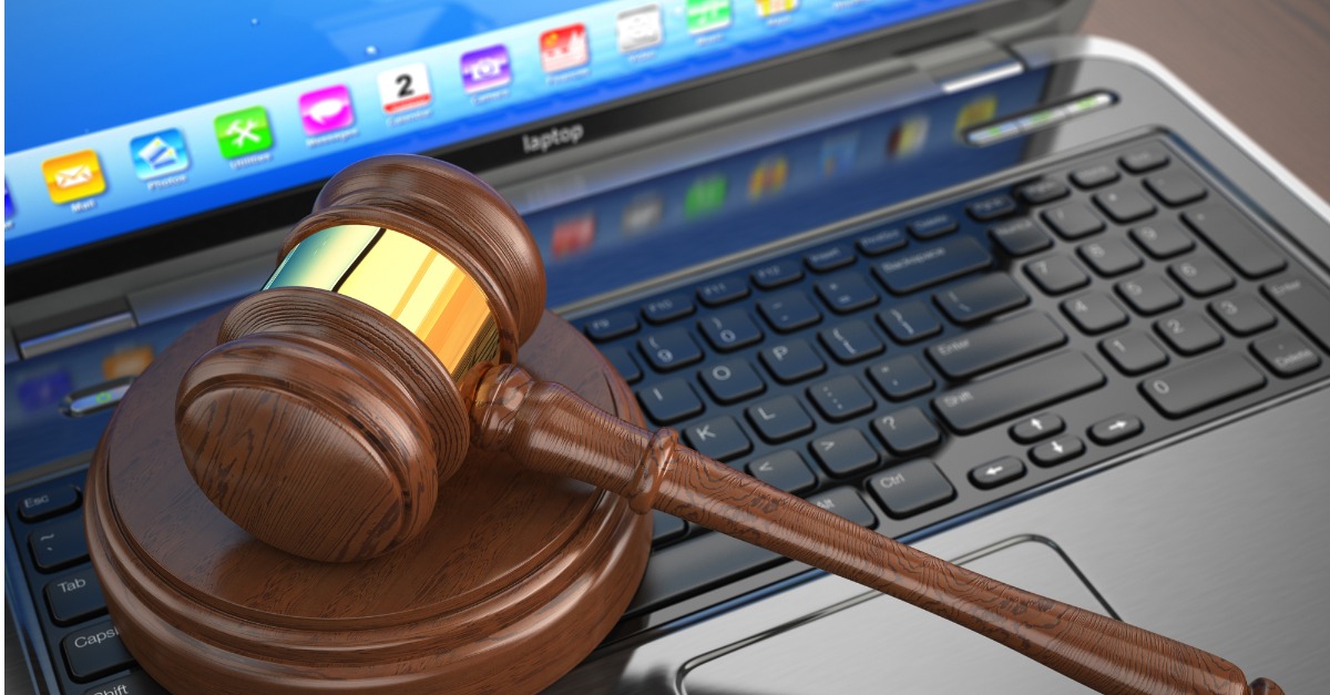 Gavel on laptop with applications on screen