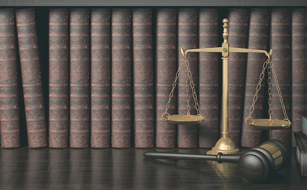 Legal scales and gavel in front of books